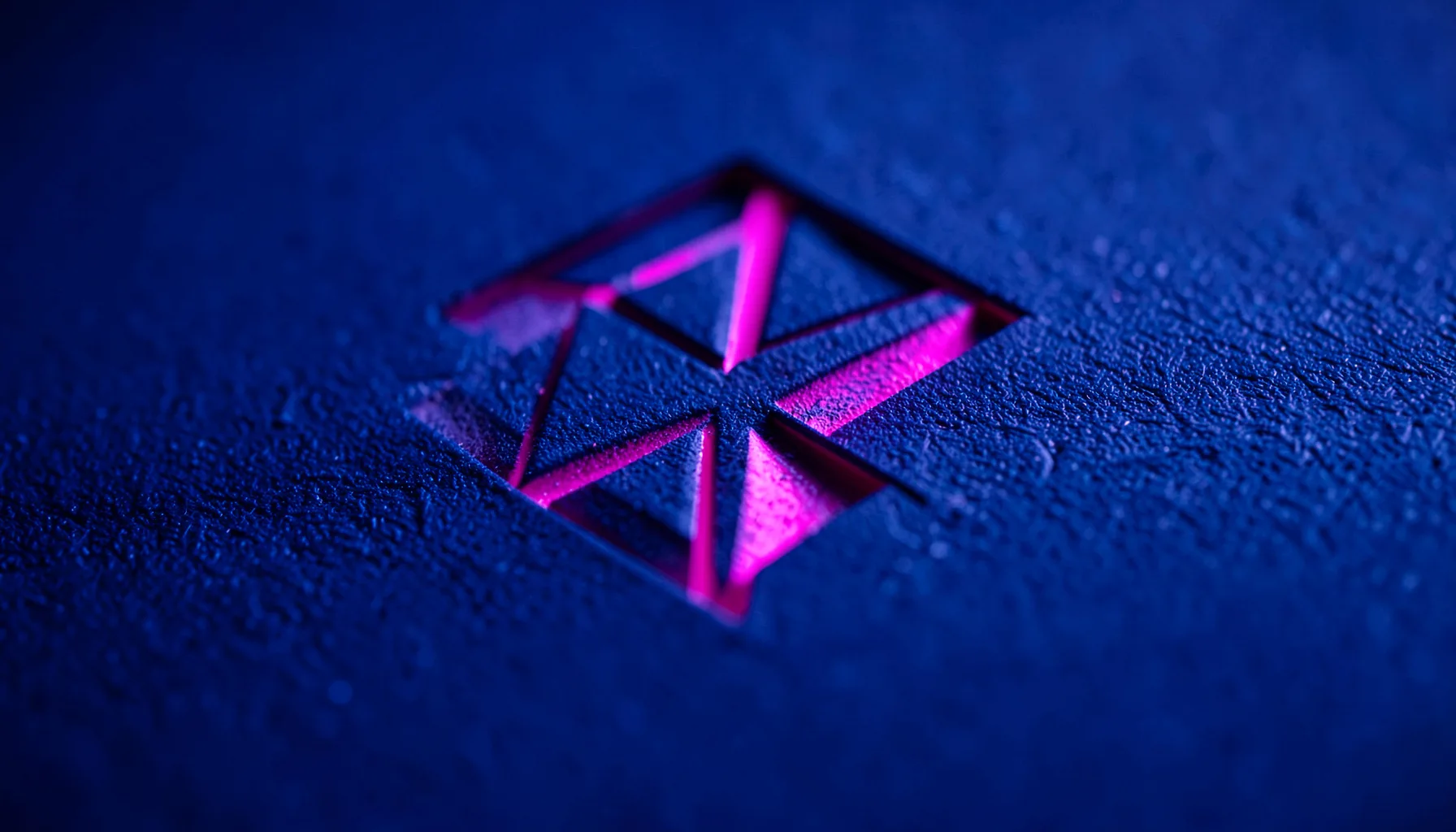 Deep indigo abstract geometric logo mark with neon magenta accent